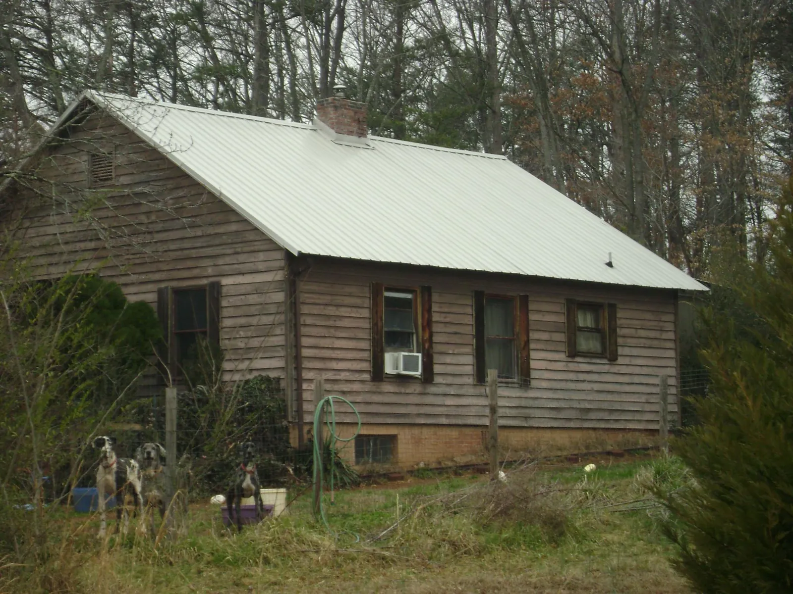 White metal roof on an old wood sided farmhouse, from a Metal Roof Installation job in Kingston Springs